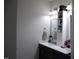 Bathroom with a double sink vanity and storage shelves at 2471 Golden Forest Dr, Franklinton, NC 27525