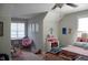 Bright bedroom featuring neutral walls, window, ceiling fan, and cute decorations and plush toys at 2471 Golden Forest Dr, Franklinton, NC 27525