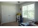 Bright bedroom featuring neutral walls, window, closet doors, and cute decorations at 2471 Golden Forest Dr, Franklinton, NC 27525