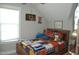 Cozy bedroom featuring hardwood bed frame, decorative accents, and natural light from the window at 2471 Golden Forest Dr, Franklinton, NC 27525