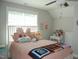 Bedroom featuring bright walls, a window, ceiling fan, white headboard, and a quilt at 2471 Golden Forest Dr, Franklinton, NC 27525