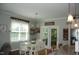 Bright dining area with white table and chairs adjacent to the kitchen and outdoor access at 2471 Golden Forest Dr, Franklinton, NC 27525