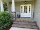 View of the home's front porch and brick steps, and the white front door at 2471 Golden Forest Dr, Franklinton, NC 27525