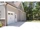 Exterior view showing a one-car garage and side entrance to the home and driveway at 2471 Golden Forest Dr, Franklinton, NC 27525