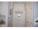 Hallway with white wainscoting, decorative hooks, and access to other rooms at 2471 Golden Forest Dr, Franklinton, NC 27525
