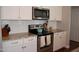 Modern kitchen with stainless steel appliances, subway tile backsplash, and ample counter space at 2471 Golden Forest Dr, Franklinton, NC 27525