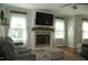 Inviting living room featuring a cozy fireplace, neutral tones, and ample natural light at 2471 Golden Forest Dr, Franklinton, NC 27525