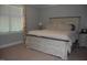 Bedroom with a decorative bed frame, carpet, and a window at 2471 Golden Forest Dr, Franklinton, NC 27525