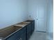 Bathroom showing new blue vanity with gold hardware adjacent to the door at 257 Marvel Dr # 135, Rolesville, NC 27571