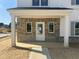 Charming brick front porch with white columns and a concrete walkway, welcoming visitors to the home at 257 Marvel Dr # 135, Rolesville, NC 27571