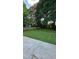 The backyard has a concrete patio, wooden fence, and lots of green grass and beautiful green trees at 2725 Westchester Dr, Burlington, NC 27217