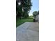 The backyard has a concrete patio, wooden fence, and lots of green grass and beautiful green trees at 2725 Westchester Dr, Burlington, NC 27217