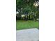The backyard has a concrete patio, wooden fence, and lots of green grass and beautiful green trees at 2725 Westchester Dr, Burlington, NC 27217