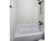 White tiled shower and tub with black fixtures at 2725 Westchester Dr, Burlington, NC 27217