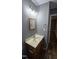 Bathroom vanity with wooden cabinet, light fixtures and square mirror at 2725 Westchester Dr, Burlington, NC 27217