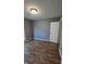 A bedroom with neutral paint, wood-look flooring and a door that leads to a closet at 2725 Westchester Dr, Burlington, NC 27217