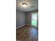 This bedroom has neutral paint, wood-look flooring, and a window with natural light at 2725 Westchester Dr, Burlington, NC 27217