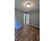 Bedroom with wood-look flooring, and a white door leading to other rooms at 2725 Westchester Dr, Burlington, NC 27217