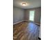 Bedroom featuring wood floors, painted gray walls, and a window at 2725 Westchester Dr, Burlington, NC 27217