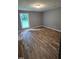 A bright bedroom with wood flooring and a large window at 2725 Westchester Dr, Burlington, NC 27217