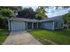 The exterior of this home is light blue with a gray roof and a white garage door at 2725 Westchester Dr, Burlington, NC 27217