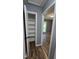 Hallway with view of room, closet, and hardwood style floors at 2725 Westchester Dr, Burlington, NC 27217