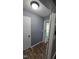 Hallway with modern floors, grey walls, and a glimpse of the home's exterior through the front door at 2725 Westchester Dr, Burlington, NC 27217