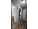 This hallway has wood floors, two doors, a light in the ceiling and a neutral paint color at 2725 Westchester Dr, Burlington, NC 27217