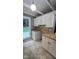 View of the kitchenette with white cabinets and tile countertops at 2725 Westchester Dr, Burlington, NC 27217