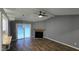 Bright living room with ceiling fan, modern floors, a fireplace and access to the outdoors at 2725 Westchester Dr, Burlington, NC 27217