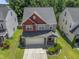 Aerial view of a two-story home featuring a well-maintained lawn, two-car garage, and pristine landscaping at 274 Marsh Creek Dr, Garner, NC 27529