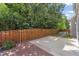 A backyard featuring a concrete and brick patio and a wood fence with lush foliage surrounding at 274 Marsh Creek Dr, Garner, NC 27529