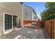 A backyard patio with concrete and brick, a wood fence, and a sliding glass door to the home at 274 Marsh Creek Dr, Garner, NC 27529
