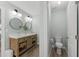 Bathroom boasting a double vanity, rustic wood cabinet, and separate toilet room at 274 Marsh Creek Dr, Garner, NC 27529