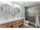 Bright bathroom with dual sinks, granite counters, updated lighting, and walk-in shower at 274 Marsh Creek Dr, Garner, NC 27529
