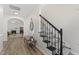 Elegant entryway showcasing a staircase with an iron railing and wood floors at 274 Marsh Creek Dr, Garner, NC 27529