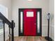 Inviting entryway featuring a striking red front door with sidelights, complemented by wood floors at 274 Marsh Creek Dr, Garner, NC 27529