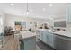 Open kitchen and dining area boasts a large center island, stainless steel appliances, and lots of natural light at 274 Marsh Creek Dr, Garner, NC 27529
