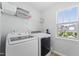 Bright laundry room features a front-load washer/dryer set and exterior views at 274 Marsh Creek Dr, Garner, NC 27529