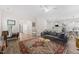 Open-concept living room with a comfortable sofa, decorative rug, and seamless flow to the kitchen at 274 Marsh Creek Dr, Garner, NC 27529