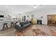 Cozy living room featuring a comfortable sofa, fireplace, and seamless flow into the kitchen and dining area at 274 Marsh Creek Dr, Garner, NC 27529