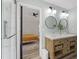 Main bathroom features a double sink vanity with framed mirrors and a door to the main bedroom at 274 Marsh Creek Dr, Garner, NC 27529