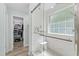 Main bathroom features a walk-in shower with a built-in bench, large window, and closet access at 274 Marsh Creek Dr, Garner, NC 27529