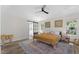 Spacious main bedroom features a ceiling fan, large windows, and a barn door leading to the main bathroom at 274 Marsh Creek Dr, Garner, NC 27529