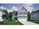 Charming two-story home with gray siding, dark shutters, and a two-car garage at 276 Meadowbark Bnd # 40, Garner, NC 27529