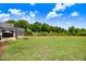 Expansive backyard features lush grass, play set, trampoline, picnic table, and an additional storage shed at 282 Brodie Rose Landing Way, Smithfield, NC 27577