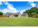 Expansive backyard featuring a well-maintained lawn, detached garage, and a charming playhouse, ideal for outdoor activities at 282 Brodie Rose Landing Way, Smithfield, NC 27577