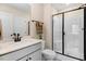Bright bathroom features a white vanity, decorative fixtures, and a glass-enclosed shower at 282 Brodie Rose Landing Way, Smithfield, NC 27577