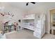 Charming bedroom featuring a bunk bed with stairs, a bookshelf, and playful decor at 282 Brodie Rose Landing Way, Smithfield, NC 27577