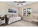 Cozy bedroom with a daybed, neutral colors, and a bright window overlooking the front yard at 282 Brodie Rose Landing Way, Smithfield, NC 27577